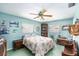 Serene bedroom with light blue walls, a floral comforter, and ample natural light from two windows at 10400 112Th Way, Largo, FL 33778