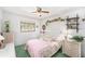 Bright bedroom with floral accents, featuring a ceiling fan and natural light at 10400 112Th Way, Largo, FL 33778