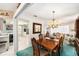 Dining room with wood table, chandelier, and view into the adjacent living room at 10400 112Th Way, Largo, FL 33778