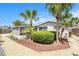 Charming single-story home with tropical landscaping, rock beds, and a cozy screened-in porch at 10400 112Th Way, Largo, FL 33778