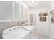Bright laundry room with white appliances and cabinetry, and tiled floor at 10400 112Th Way, Largo, FL 33778