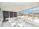 Enclosed patio area featuring outdoor furniture, screens, and an exterior view at 10400 112Th Way, Largo, FL 33778