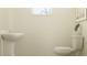 Cozy powder room with pedestal sink, toilet, and decorative plant at 10812 Keato Beach Ct, Tampa, FL 33647