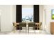 The dining room boasts a simple table, seating for six and great natural light at 10812 Keato Beach Ct, Tampa, FL 33647