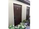 Two storage units with brown doors and unit numbers 96 and 103, surrounded by green plants at 1100 E Bay Dr # 96, Largo, FL 33770