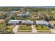 Great aerial view of the property showing a neatly maintained lawn, driveway, and mature trees surrounding the house at 11348 59Th Ter, Seminole, FL 33772