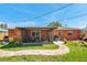 Charming backyard view showcasing the exterior of the home and a delightful screened-in patio area at 11348 59Th Ter, Seminole, FL 33772