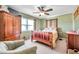 Comfortable bedroom featuring a cozy armchair, ceiling fan, and coordinating furnishings for a relaxing space at 11348 59Th Ter, Seminole, FL 33772