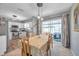 Inviting dining area with sliding glass doors leading to outdoor space and well-lit kitchen views at 11348 59Th Ter, Seminole, FL 33772