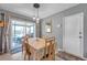 Bright dining area with a sliding door, open to the outside, and a white door leading to other rooms at 11348 59Th Ter, Seminole, FL 33772