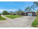 Charming single-story home with a well-manicured lawn, a spacious driveway, and an attached garage at 11348 59Th Ter, Seminole, FL 33772