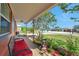 Cozy covered porch with seating, bird bath, and lush landscaping offering curb appeal at 11348 59Th Ter, Seminole, FL 33772