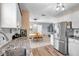 Bright kitchen featuring stainless steel appliances, white cabinets, and a seamless flow to the dining area at 11348 59Th Ter, Seminole, FL 33772