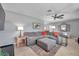Comfortable living room with a large sectional sofa, ceiling fan, and stylish decor on tile floors at 11348 59Th Ter, Seminole, FL 33772