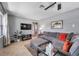 Relax in this cozy living room with a plush gray sofa and a large-screen TV for entertainment at 11348 59Th Ter, Seminole, FL 33772