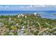 An aerial view shows a house with surrounding mature trees, neighborhoods, and water views at 116 24Th S Ave, St Petersburg, FL 33705