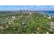 Scenic aerial view of a neighborhood with homes nestled among lush greenery and a distant cityscape at 116 24Th S Ave, St Petersburg, FL 33705