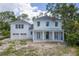 Charming two-story home featuring a covered front porch with stately columns and a two-car garage at 116 24Th S Ave, St Petersburg, FL 33705