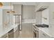 Bright kitchen features gray cabinets, stainless steel appliances and a large farmhouse sink at 116 24Th S Ave, St Petersburg, FL 33705