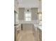 Modern kitchen featuring gray cabinets, stainless steel appliances, white countertops and hardware, and light wood floors at 116 24Th S Ave, St Petersburg, FL 33705