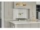 Modern kitchen features gray cabinets, white countertops, marble backsplash, and brass hardware at 116 24Th S Ave, St Petersburg, FL 33705