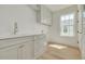 Light and airy laundry room features sink, storage and natural light at 116 24Th S Ave, St Petersburg, FL 33705