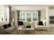 Airy living room with large windows, a sectional sofa, and modern decor at 11757 E 74Th Cir, Palmetto, FL 34221