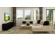 Comfortable living room featuring neutral tones, a plush sectional, and large bright windows at 11757 E 74Th Cir, Palmetto, FL 34221