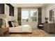 Comfortable main bedroom features a decorative black accent wall, large windows, and stylish furniture at 11757 E 74Th Cir, Palmetto, FL 34221