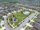 An aerial view of a Primary-planned community featuring a pool, playground, and green spaces at 1203 Custer Bayou Street, Ruskin, FL 33570
