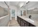 Bathroom featuring double sinks, granite countertop, and a glass-enclosed shower at 1203 Custer Bayou Street, Ruskin, FL 33570