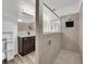 Well-lit bathroom with a granite vanity, glass-enclosed shower, and modern fixtures at 1203 Custer Bayou Street, Ruskin, FL 33570