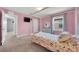 Bedroom painted pink with a canopy bed, complemented by matching furniture at 1203 Custer Bayou Street, Ruskin, FL 33570