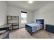 Well-lit bedroom with stylish blue furnishings, a desk, and a view from the window at 1203 Custer Bayou Street, Ruskin, FL 33570
