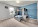 bedroom with a gray bunk bed, a desk and blue accent wall at 1203 Custer Bayou Street, Ruskin, FL 33570