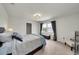 Serene bedroom featuring a large window, carpet flooring, and neutral decor at 1203 Custer Bayou Street, Ruskin, FL 33570