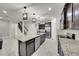 Stylish open kitchen boasts stainless appliances, dark wood cabinets, and a granite-topped island at 1203 Custer Bayou Street, Ruskin, FL 33570