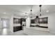 Bright, open kitchen featuring stainless steel appliances, dark wood cabinets, and a large center island at 1203 Custer Bayou Street, Ruskin, FL 33570