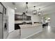 Spacious kitchen featuring dark wood cabinets, stainless steel appliances, and a large center island at 1203 Custer Bayou Street, Ruskin, FL 33570