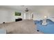 Spacious living room with a mounted TV and cozy blue sofa at 1203 Custer Bayou Street, Ruskin, FL 33570