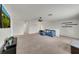 Open-concept living room featuring a mounted TV and a comfortable blue sectional at 1203 Custer Bayou Street, Ruskin, FL 33570