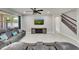 Comfortable living room with neutral tones and a brick accent wall with a mounted TV at 1203 Custer Bayou Street, Ruskin, FL 33570