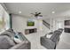 Spacious living room featuring a decorative brick wall, ceiling fan, and comfortable seating at 1203 Custer Bayou Street, Ruskin, FL 33570