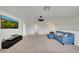 Open-concept living room featuring a mounted TV and a comfortable blue sectional at 1203 Custer Bayou Street, Ruskin, FL 33570