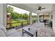 Enclosed patio with outdoor furniture, a ceiling fan, and views of the backyard at 1203 Custer Bayou Street, Ruskin, FL 33570