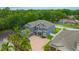 Aerial view of a beautiful landscaped two-story home with a brick driveway and lush green yard at 1229 Hillandale Reserve Dr, Tampa, FL 33613