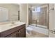 Bathroom featuring a dark wood vanity and a glass-enclosed shower-over-tub combination at 1229 Hillandale Reserve Dr, Tampa, FL 33613