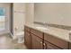 Bathroom featuring granite countertop with dark wood cabinetry, toilet, and shower stall at 1229 Hillandale Reserve Dr, Tampa, FL 33613