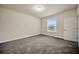 Comfortable bedroom with neutral walls, carpet, bright window for natural light, and standard closet door at 1229 Hillandale Reserve Dr, Tampa, FL 33613