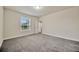 Spacious bedroom featuring plush gray carpeting and a window with natural light at 1229 Hillandale Reserve Dr, Tampa, FL 33613